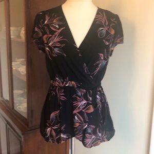 Tie-waist black patterned blouse.